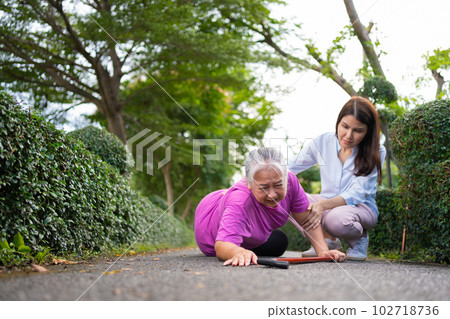 Asian senior woman fell down on lying floor because faint and limb weakness and Crying in pain form accident and her daughter came to help support. Concept of old elderly insurance and health care Asian senior woman fell down on lying floor because faint and limb weakness and Crying in pain form accident and her daughter came to help support. Concept of old elderly insurance and health care 102718736
