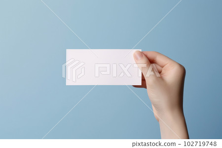 Female hand with minimalistic natural manicure holding white paper for messages and notes Copy space AI generated image 102719748