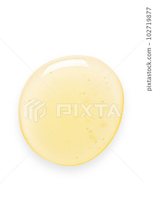 Yellow drops of gel close up. Cosmetic product for moisturizing the skin of the face or body. Isolated on a white background. Yellow drops of gel close up. Cosmetic product for moisturizing the skin of the face or body. Isolated on a white background. 102719877