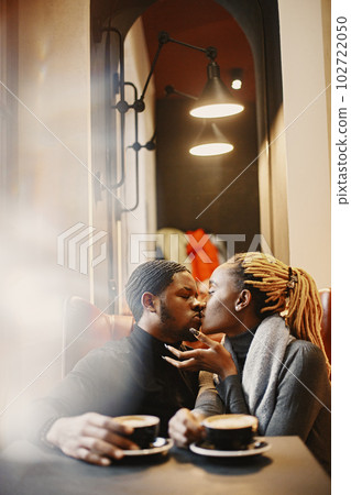 Two young people in cafe. African couple enjoying the time spending with each other. 102722050