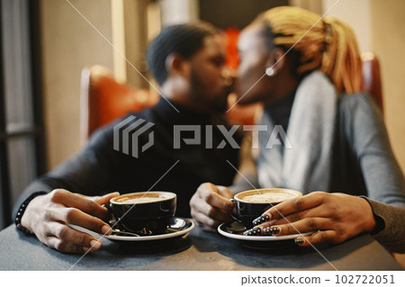 Two young people in cafe. African couple enjoying the time spending with each other. Two young people in cafe. African couple enjoying the time spending with each other. 102722051