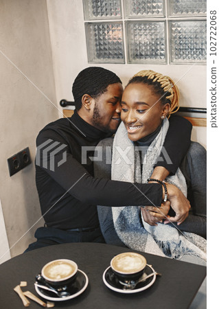 Two young people in cafe. African couple enjoying the time spending with each other. 102722068
