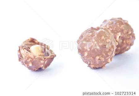 chocolate ball stuffed peanut biting arranging on white background chocolate ball stuffed peanut biting arranging on white background 102723314
