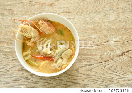 boiled river shrimp with chicken in Thai spicy herb soup or tom yum kung on bowl boiled river shrimp with chicken in Thai spicy herb soup or tom yum kung on bowl 102723316