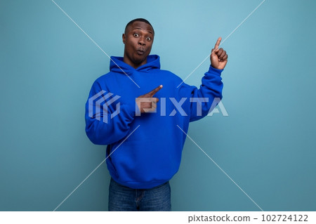 authentic ethnic young african man in stylish hoodie on blue background 102724122
