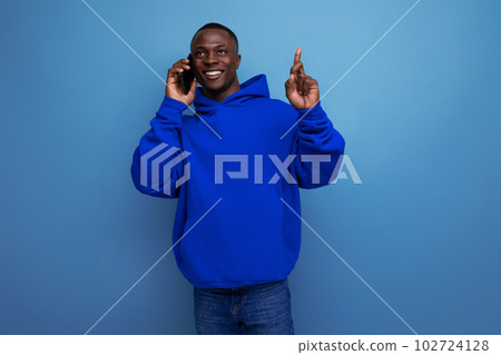 smiling young american consultant man with short haircut holding smartphone smiling young american consultant man with short haircut holding smartphone 102724128
