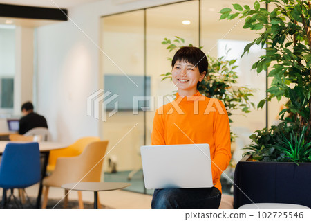 Young woman working in a designer office Young woman working in a designer office 102725546