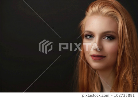 Portrait of smiling redhead young woman 102725891