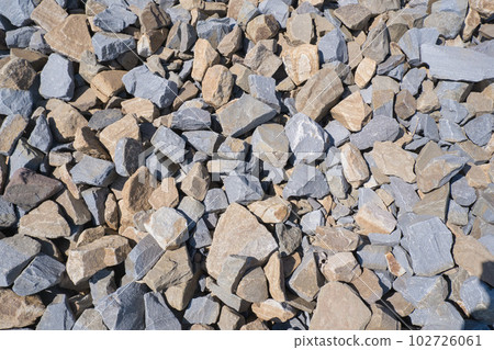 Gravel texture. Pebble stone background. Light grey closeup small rocks. Top view of ground gravel road. 102726061