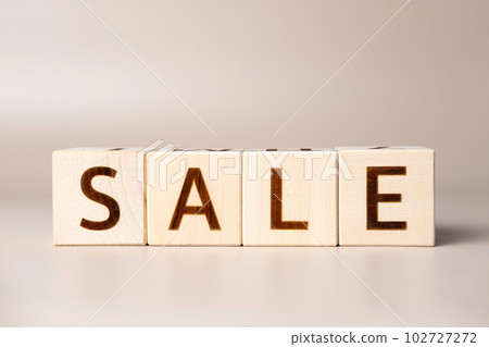 The word SALE on wooden cubes on a beige neutral studio background. Copy Space. Written. Text words matter. Conceptual Photo. Shopping symbol. The concept of volume increase make business grow 102727272
