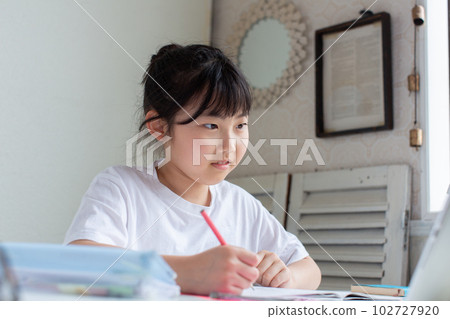 Elementary school students doing homework using a tablet Elementary school students doing homework using a tablet 102727920
