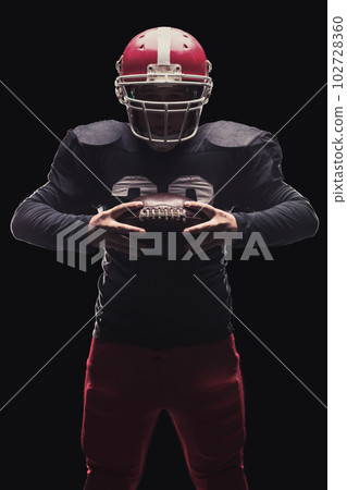Football player on dark background Football player on dark background 102728360