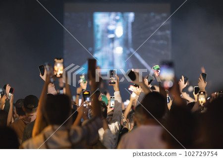 People shoot the concert on their phones People shoot the concert on their phones 102729754