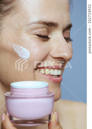 happy young 40 years old woman with cosmetic cream jar 102729932