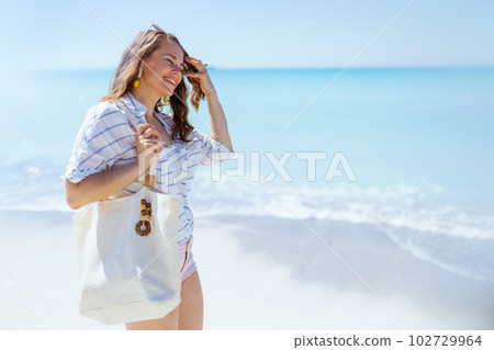 happy modern 40 years old woman at beach happy modern 40 years old woman at beach 102729964