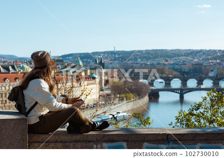 woman in sweatshirt in Prague Czech Republic enjoying promenade 102730010