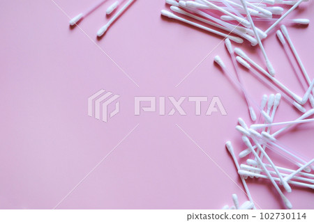 cotton swabs on a pink background on the right, cosmetic and medical accessories, a beauty salon banner, with a place for text cotton swabs on a pink background on the right, cosmetic and medical accessories, a beauty salon banner, with a place for text 102730114