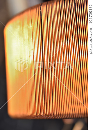 Copper coil. Copper wire wound on a coil. Copper scrap. 102730582