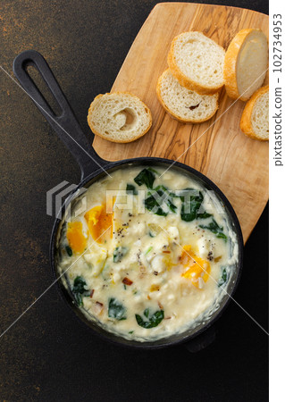 Fried eggs with cheese, spinach leaves Fried eggs with cheese, spinach leaves 102734953