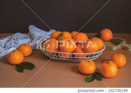 the still life of orange, or a mandarin on black background. the still life of orange, or a mandarin on black background. 102736190