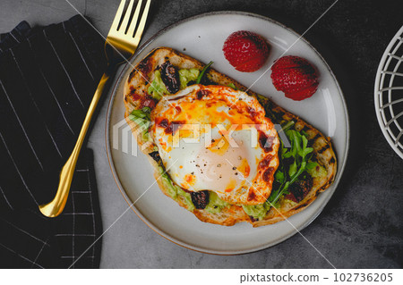 healthy diet and eating food made with sourdough and green avocado and arugula. healthy diet and eating food made with sourdough and green avocado and arugula. 102736205