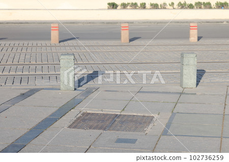 A street border painted in white and black on the background of the road, minimalism. 102736259
