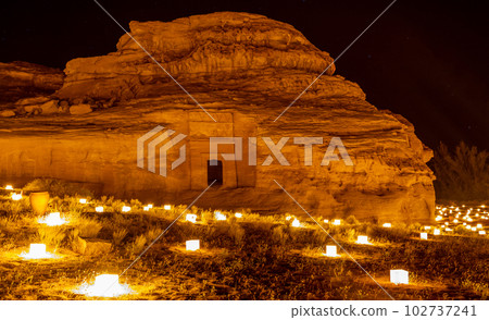 Ancient tombs of Hegra city illuminated during the night, Al Ula, Saudi Arabia 102737241