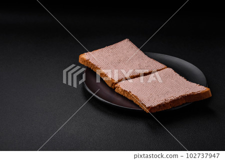 Delicious crispy toast with chicken or goose pate with salt and spices 102737947