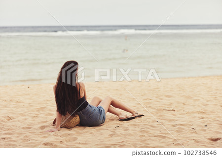 sea woman travel water freedom sand beach nature vacation sitting smile 102738546