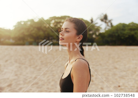 sunset woman ocean lifestyle beach summer smile girl vacation sea sand 102738548