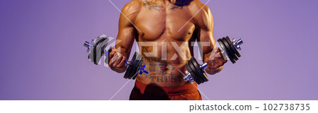 Muscular man doing exercise with weight dumbbells on studio background. Strength and motivation Muscular man doing exercise with weight dumbbells on studio background. Strength and motivation 102738735