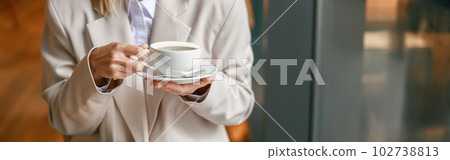 Close up of businesswoman having coffee break time during working day in cafe 102738813