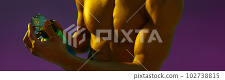 Close up of sporty man with muscled naked torso holding bottle with water on studio background 102738815