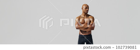 Attractive sporty man with muscled naked body on white studio background looking at side 102739081