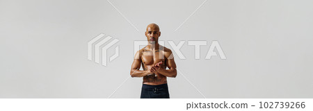Attractive sporty man with muscled naked body on white studio background looking at camera Attractive sporty man with muscled naked body on white studio background looking at camera 102739266