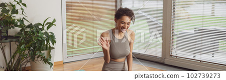 Afro american woman talking with fitness instructor by video call before online classes at home Afro american woman talking with fitness instructor by video call before online classes at home 102739273