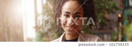 Smiling professional woman florist with seedlings in floral studio. Gardening concept Smiling professional woman florist with seedlings in floral studio. Gardening concept 102739335