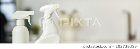 Clean up. Close up shot of detergent bottles and stack of rugs on kitchen surface 102739359
