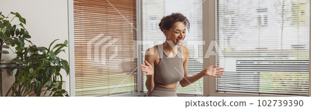 Afro american woman talking with fitness instructor by video call after online classes at home Afro american woman talking with fitness instructor by video call after online classes at home 102739390