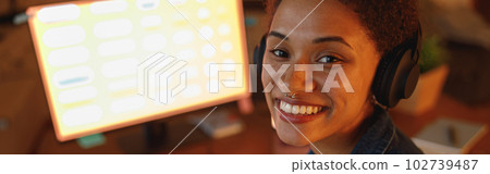 Afro american woman graphic designer drinking tea during break at home office. Freelance concept Afro american woman graphic designer drinking tea during break at home office. Freelance concept 102739487