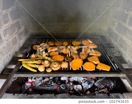 Fresh juicy vegetables being grilled in a brick oven Fresh juicy vegetables being grilled in a brick oven 102741635