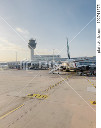 Passenger plane stands in front of the airport building at the airfield 102741775