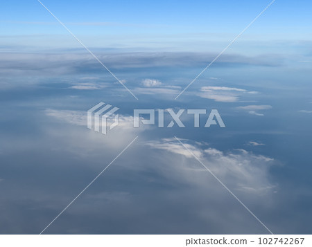 White cirrus clouds on a bright turquoise sky. Top view 102742267