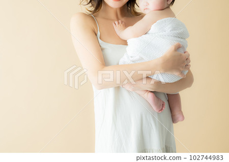 A mother holding a baby 102744983