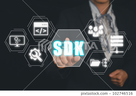 SDK - Software development kit programming language technology concept, Business woman hand touching SDK icon on virtual screen. 102746516