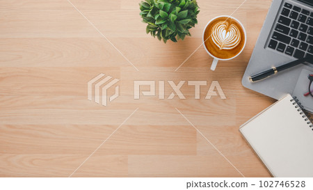 Office desk workplace with laptop computer, notebook, pen and cup of coffee, Top view flat lay with copy space. 102746528