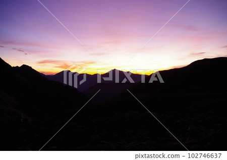 Dawn over the Tateyama mountain range seen from Kenzawa 102746637