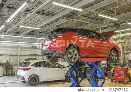 Auto repair shop - vehicle on lift 102747412