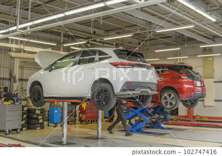 Auto repair shop - vehicle on lift 102747416