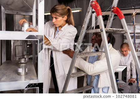 Young woman solving puzzles in quest room Young woman solving puzzles in quest room 102748081